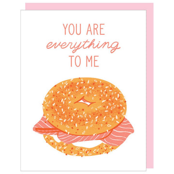 Greeting card with an everything bagel design, featuring a loving message, set against a white backdrop.