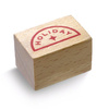 Wooden planner stamp with "Holiday" printed in red, set inside a semi-circle.