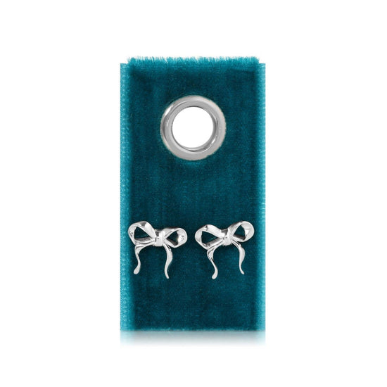Silver bow earrings on velvet tag with grommet detail.