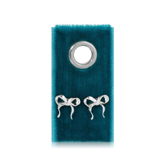 Silver bow earrings on velvet tag with grommet detail.