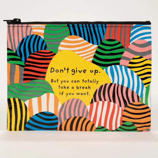 Zipper pouch by Blue Q with colorful striped hills and a yellow text bubble that reads "Don't give up."
