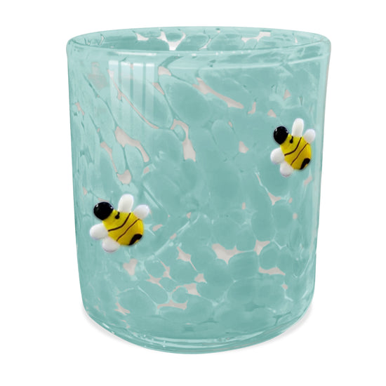 Teal candle holder by Icon, decorated with textured glass and small bee appliques.