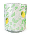 Scented candle with a white wax fill, decorated with green and white spots and yellow lemon accents.