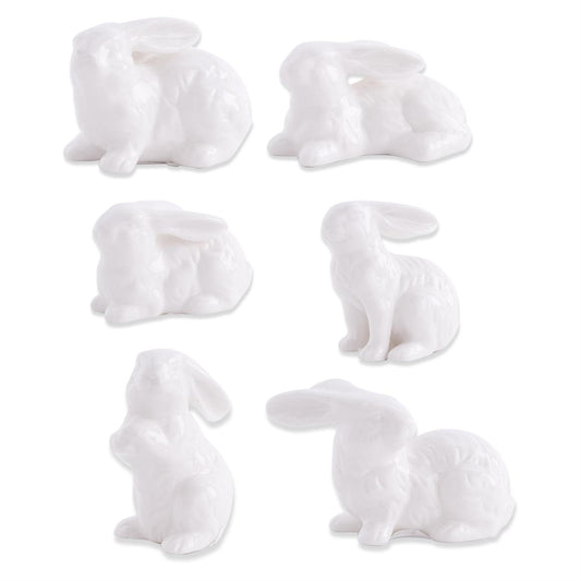 Assorted white porcelain bunnies by Creative Brands in a variety of poses.