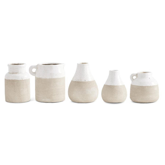 Ceramic two-tone glazed pots with beige bottoms and white tops, from an eye-level perspective.
