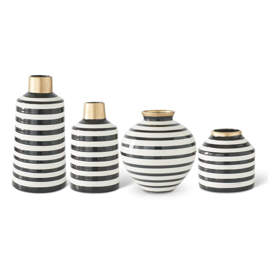 Set of four black and white striped vases with gold accents on a white background