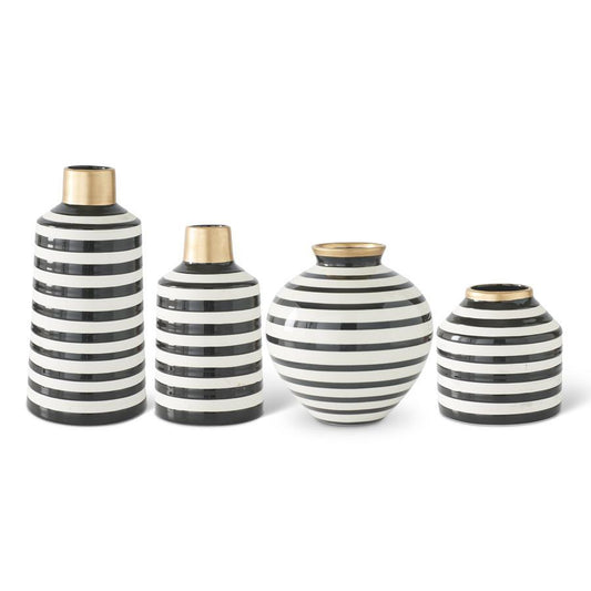 Set of four black and white striped vases with gold accents on a white background