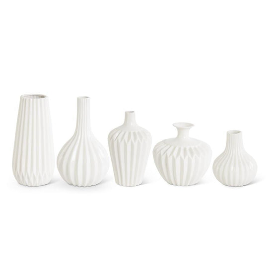 White porcelain vase by ACCORDION, with textured vertical and geometric patterns, in assorted shapes.