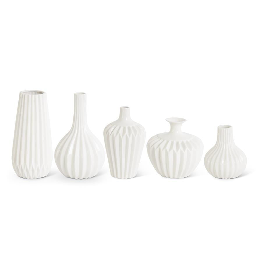 White porcelain vase by ACCORDION, with textured vertical and geometric patterns, in assorted shapes.