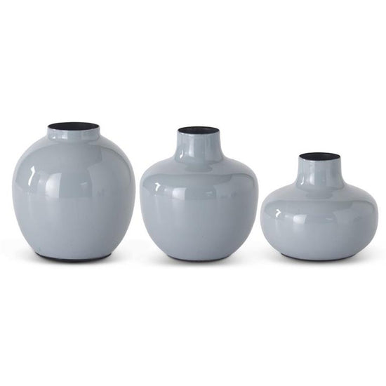 Gray enameled metal vase with black interior trim, arranged in graduating sizes.