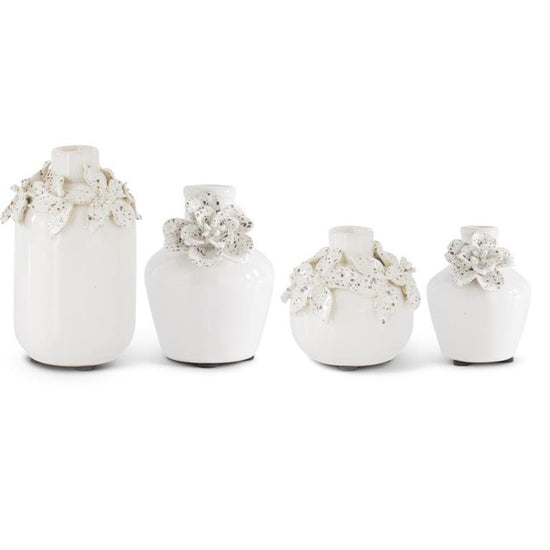 White ceramic vases with raised flower detail by Sagebrook Home, set of four in varying sizes.