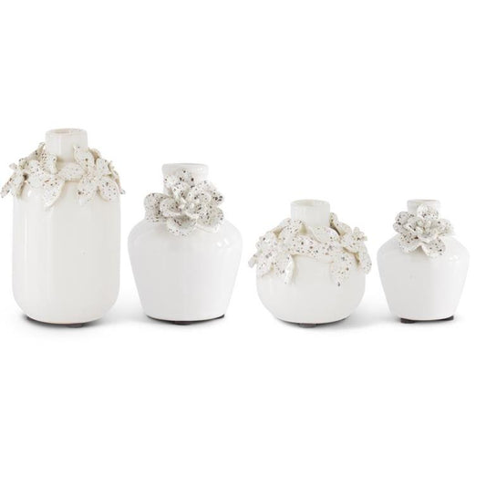 White ceramic vases with raised flower detail by Sagebrook Home, set of four in varying sizes.