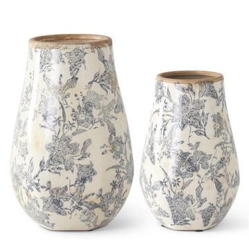 White and black floral vases with wooden rims, featuring a delicate floral pattern.