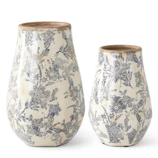 White and black floral vases with wooden rims, featuring a delicate floral pattern.