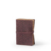 Brown leather journal with intricate pattern on a white background