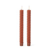 Two twisted candles on a white background