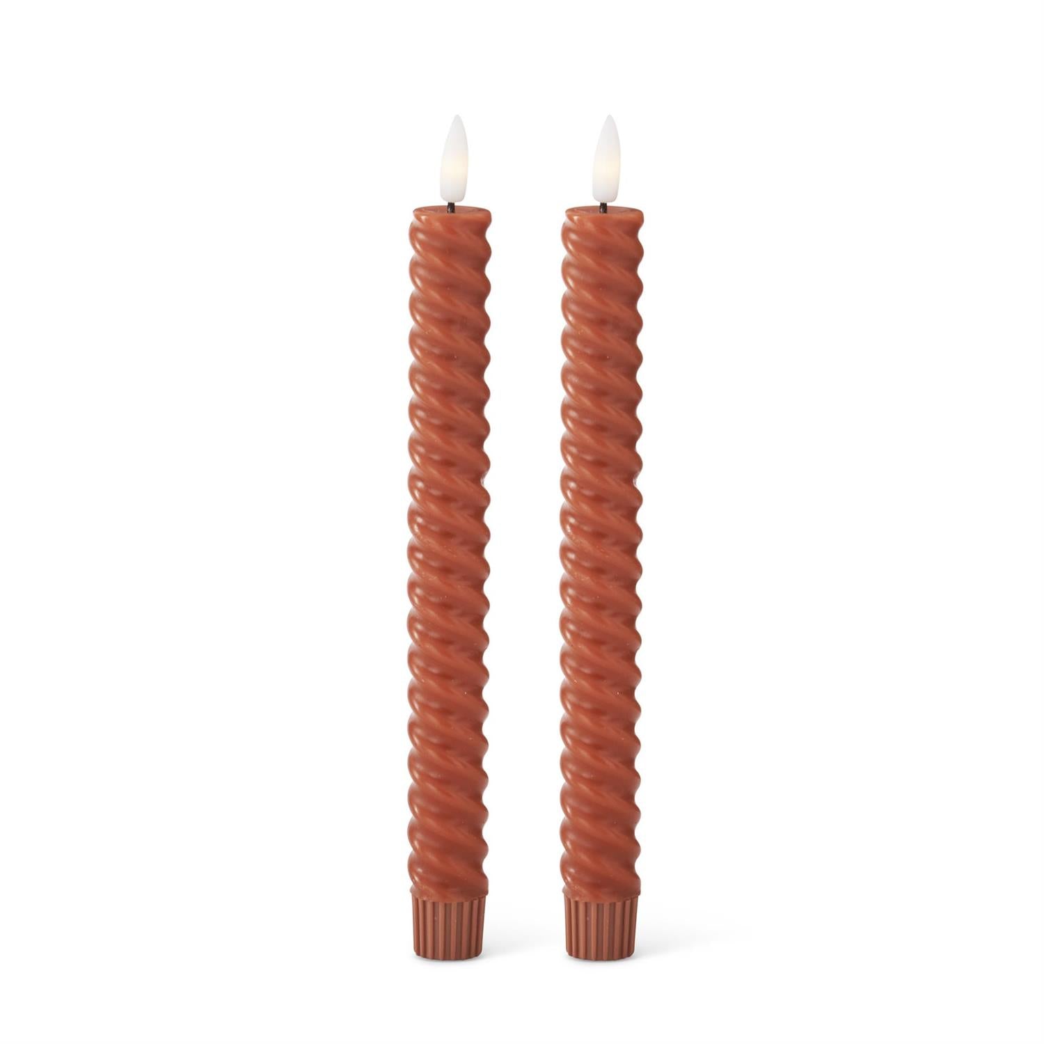 Two twisted candles on a white background