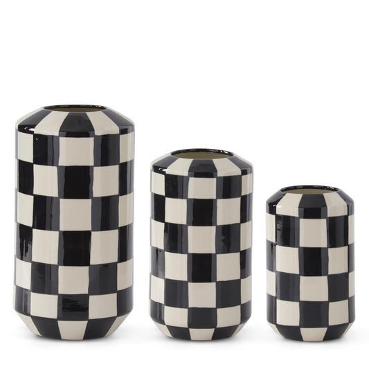Three black and white checkered vases of different sizes on a white background