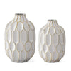 White and gold embossed vases by Studio A Home with oval geometric pattern on a glossy surface.
