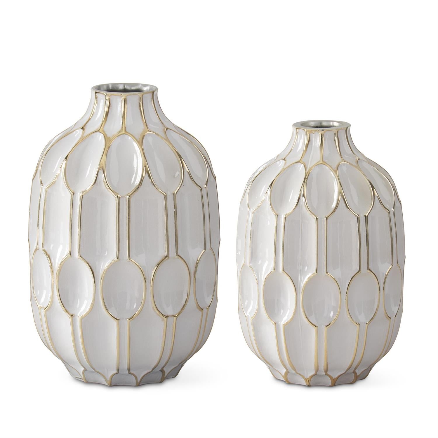 White and gold embossed vases by Studio A Home with oval geometric pattern on a glossy surface.
