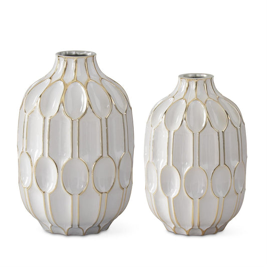White and gold embossed vases by Studio A Home with oval geometric pattern on a glossy surface.
