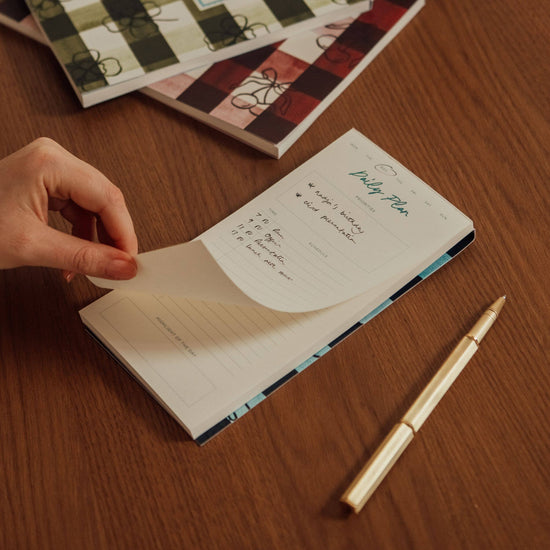 Daily planning pad from Picnic, featuring a day planner layout for prioritizing tasks and scheduling events.

