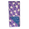 Reversible towel with magnolia and violet floral pattern by June & Lord, revealing a blue leaf print underneath.
