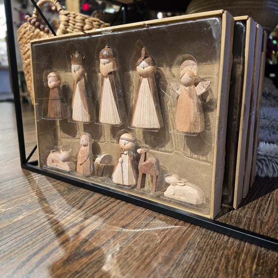 Wooden nativity figurine set in box, with minimalist design.