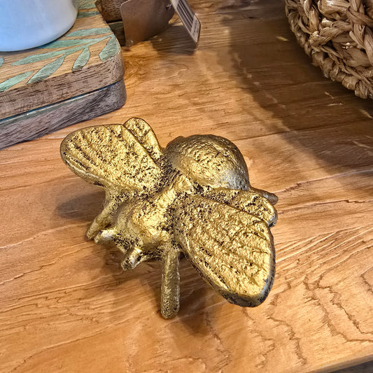 Gold-toned cast iron bee bottle opener from Cast Iron, textured surface.