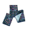 Set of three navy mini towels with floral pattern by Glitz, one folded to reveal the plain blue backing.
