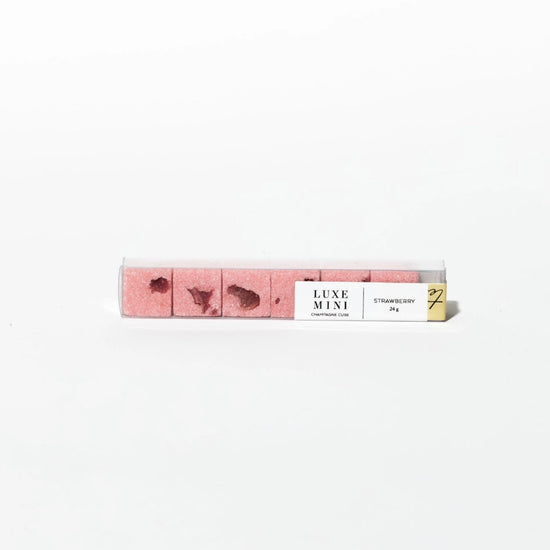 Strawberry luxe mini champagne cubes by Luxe Mini in a clear plastic container.