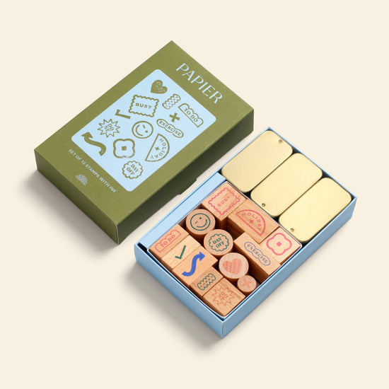Planner stamp set by Papier, including wooden stamps with icons, packed in a colorful box with golden ink pads.