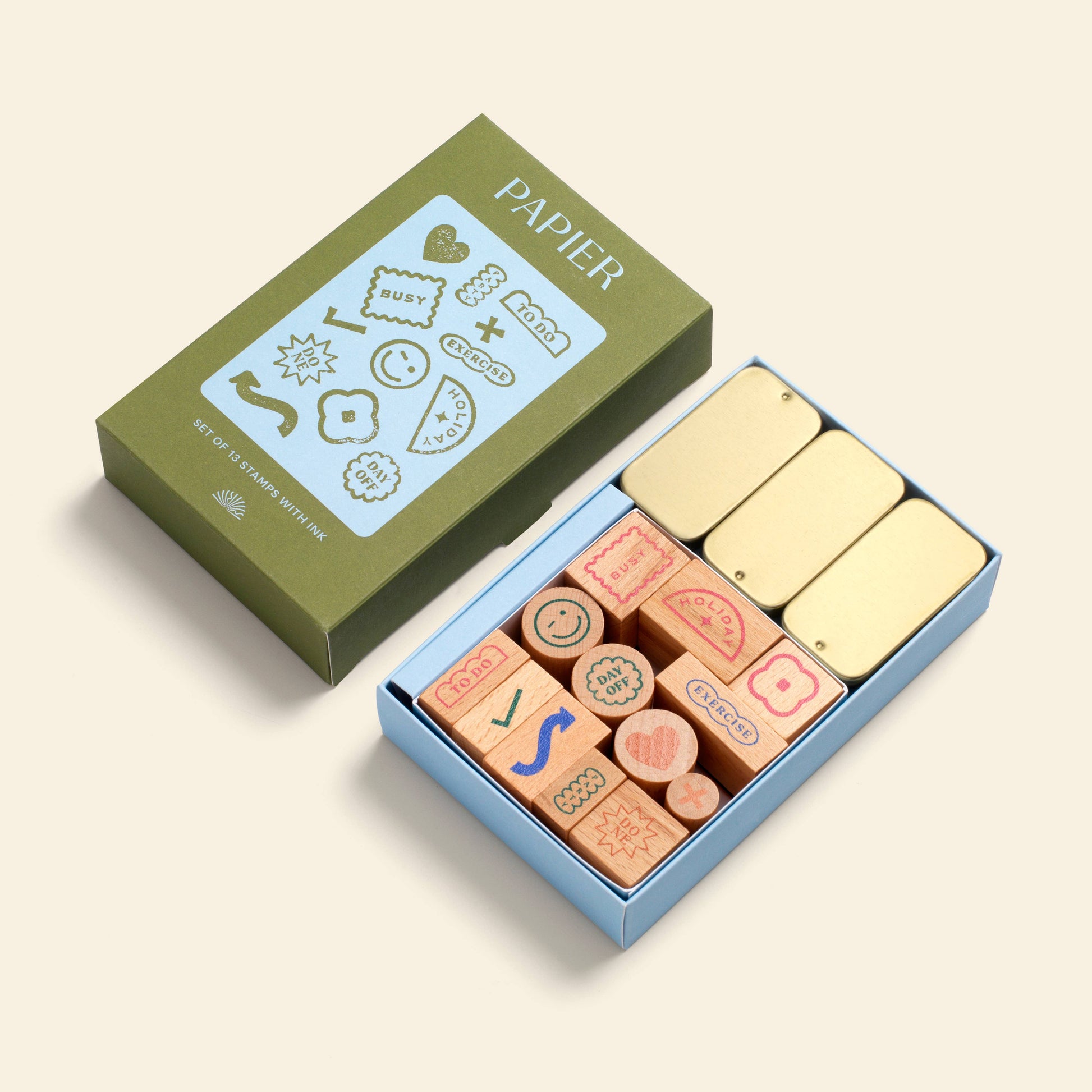 Planner stamp set by Papier, including wooden stamps with icons, packed in a colorful box with golden ink pads.