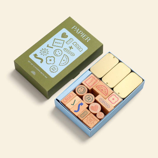 Planner stamp set by Papier, including wooden stamps with icons, packed in a colorful box with golden ink pads.