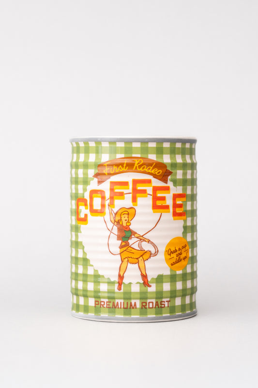 Coffee can ceramic planter with "First Rodeo Coffee" label, featuring a cowgirl graphic on a green and white gingham pattern.