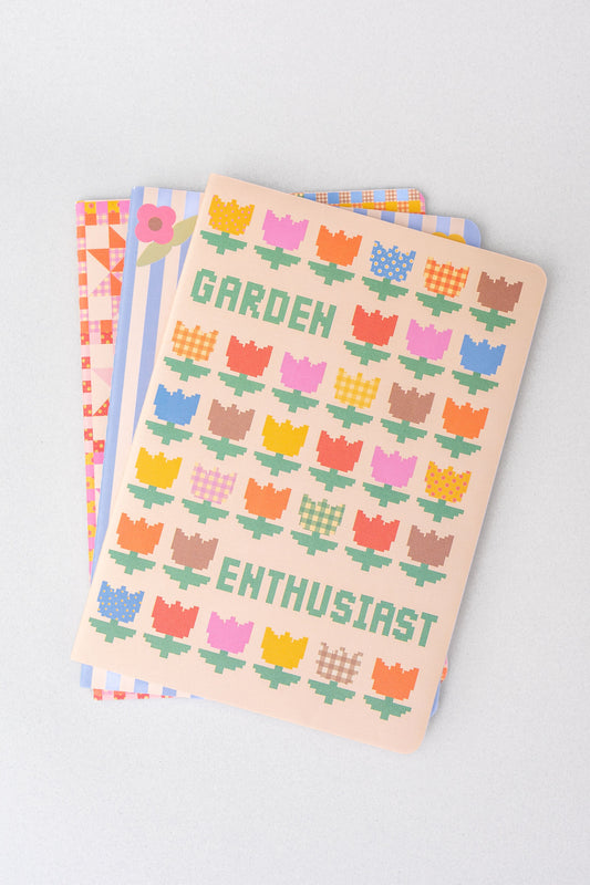 Set of three stationery notebooks with patterned covers from stationery, featuring geometric and floral designs.