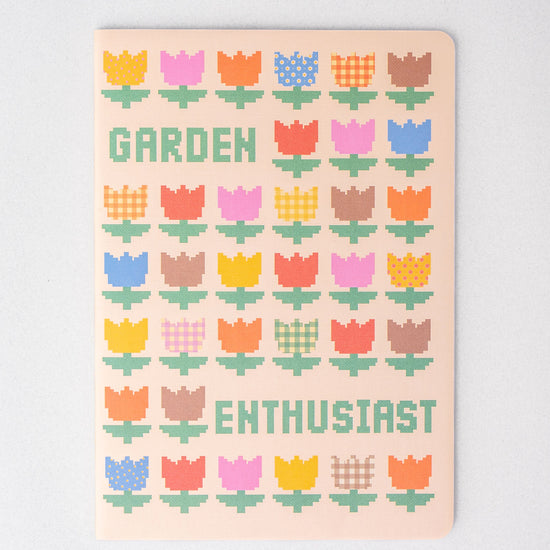 Set of three rough draft notebooks with pixelated floral pattern and lettering.