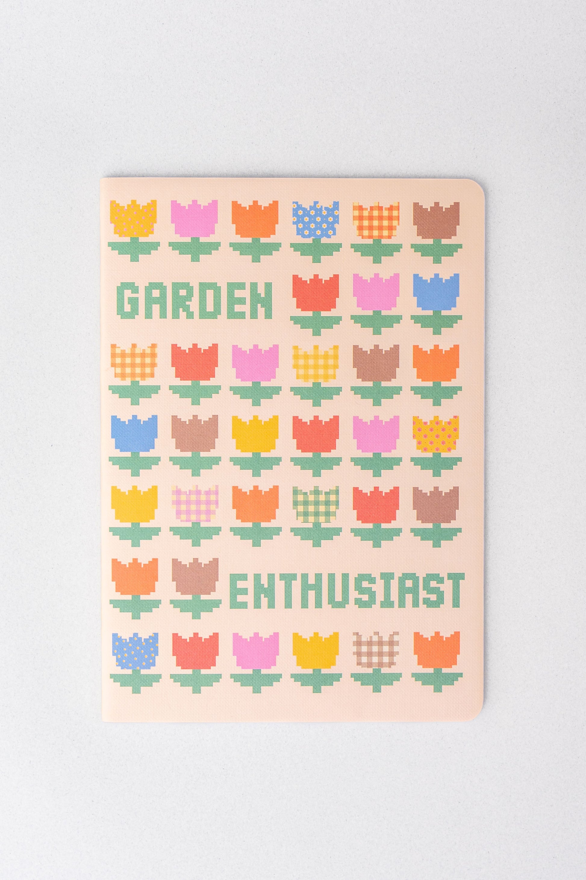 Set of three rough draft notebooks with pixelated floral pattern and lettering.