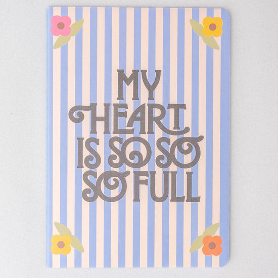 Striped notebook by Anthropologie featuring floral accents and a heartfelt message.