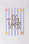 Striped notebook by Anthropologie featuring floral accents and a heartfelt message.