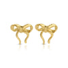 Gold bow earrings with tails on velvet tag.