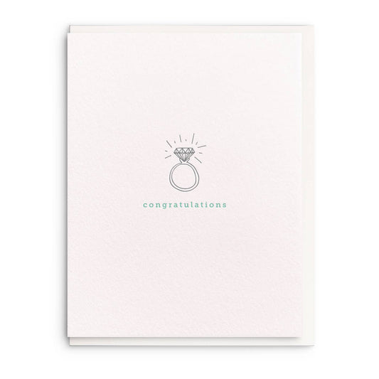 Letterpress wedding greeting card featuring a drawn ring, by an unspecified brand, with light texture and "congratulations" text.