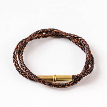 Brown braided bracelet by Flint with gold-tone clasp.