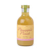 Pineapple punch cocktail mixer from Here's How, in a glass bottle with a gold cap and label.
