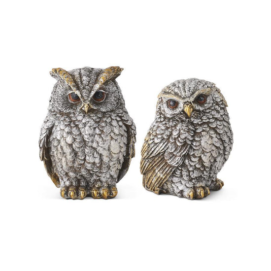 Two owl figurines on a white background