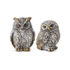 Two owl figurines on a white background