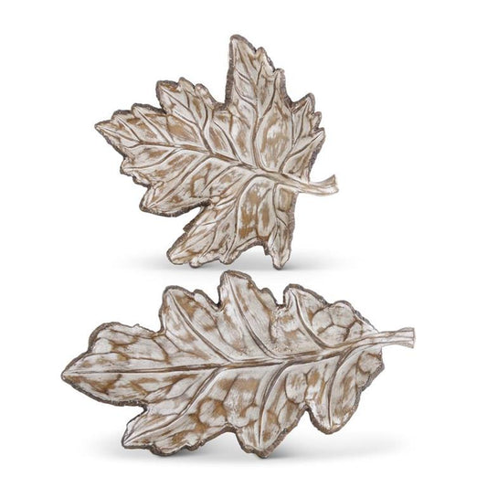 Two metallic leaf-shaped objects on a white background
