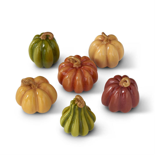 Set of decorative pumpkins and gourds in various colors on a white background