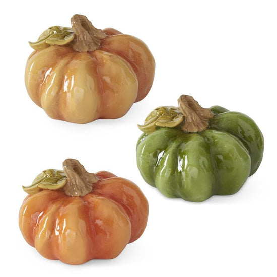 Set of three resin pumpkins by Park Designs in orange, gold and green with glossy finish.