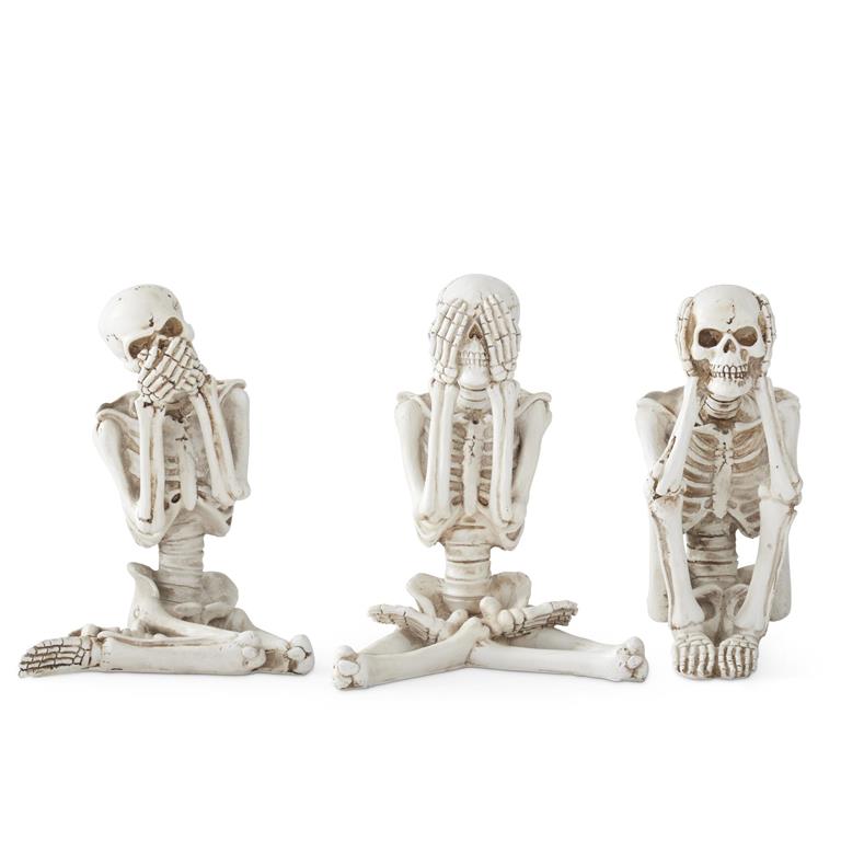Three skeleton figurines in various poses on a white background
